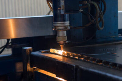 laser head cutting patterns into metal sheets 2023 11 27 05 05 10 utc scaled